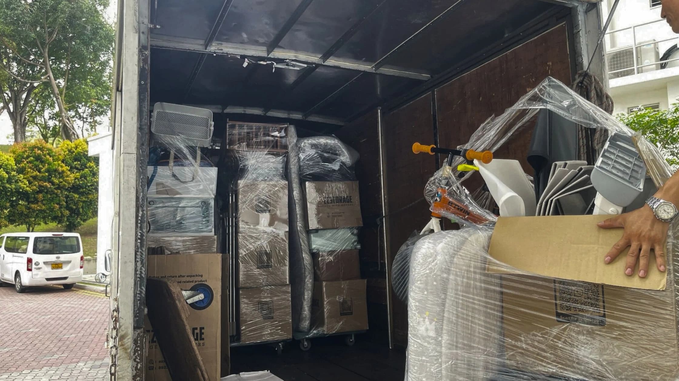 Protected furniture and cartons arranged inside a moving truck
